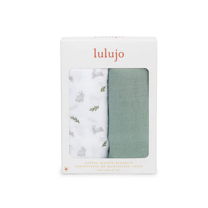 Boxed Lulujo 2-pack cotton muslin swaddles in packaging with one green and one white bunny-print blanket visible through the front window.