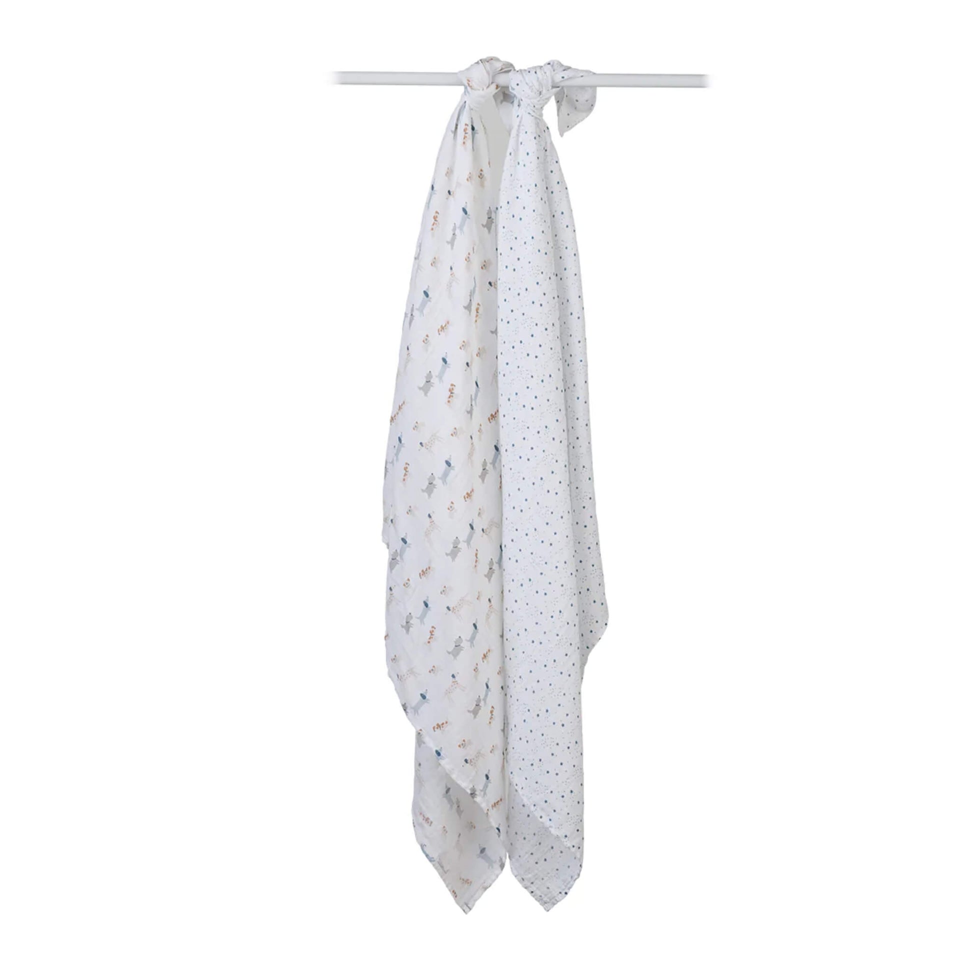 Two muslin swaddles knotted over a white rod, one with a dog print and one with a scattered star pattern.