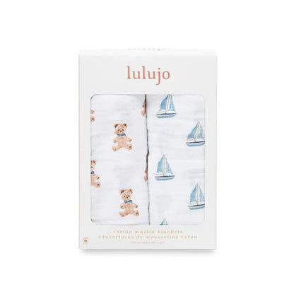 Boxed Lulujo 2-pack cotton muslin swaddles showing one bear print and one sailboat print through the packaging window.