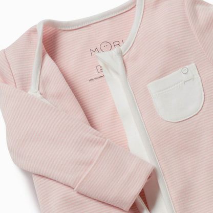 A close-up of a pink striped baby sleepsuit showing the soft neckline, concealed zip and a small white chest pocket.