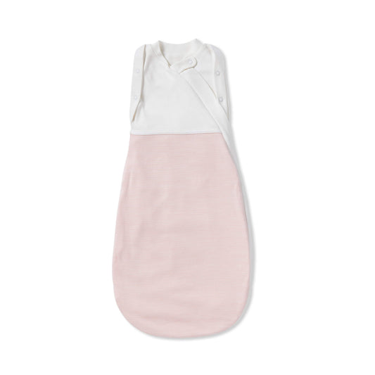 A MORI Newborn Swaddle Bag in Blush Stripe laid flat, showing the soft white upper panel with poppers and the pink striped lower section designed for gentle, secure wrapping.