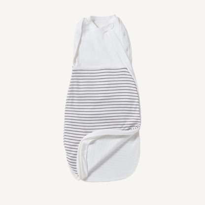 A newborn swaddle bag in grey stripe shown partially unzipped at the bottom, revealing the soft inner lining and wrap-style chest panel with poppers.