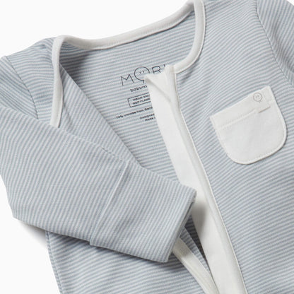 Close-up of a blue striped sleepsuit shown partly unzipped to reveal the inner seams and the soft fabric texture.
