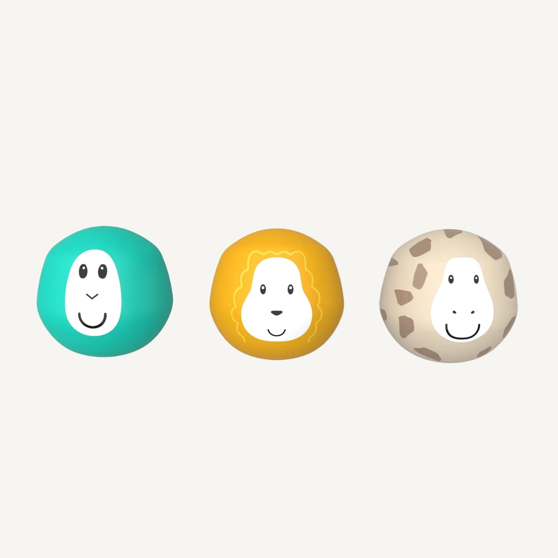 Three round bath toy balls with smiling animal faces arranged in a row, including turquoise, yellow, and beige characters.