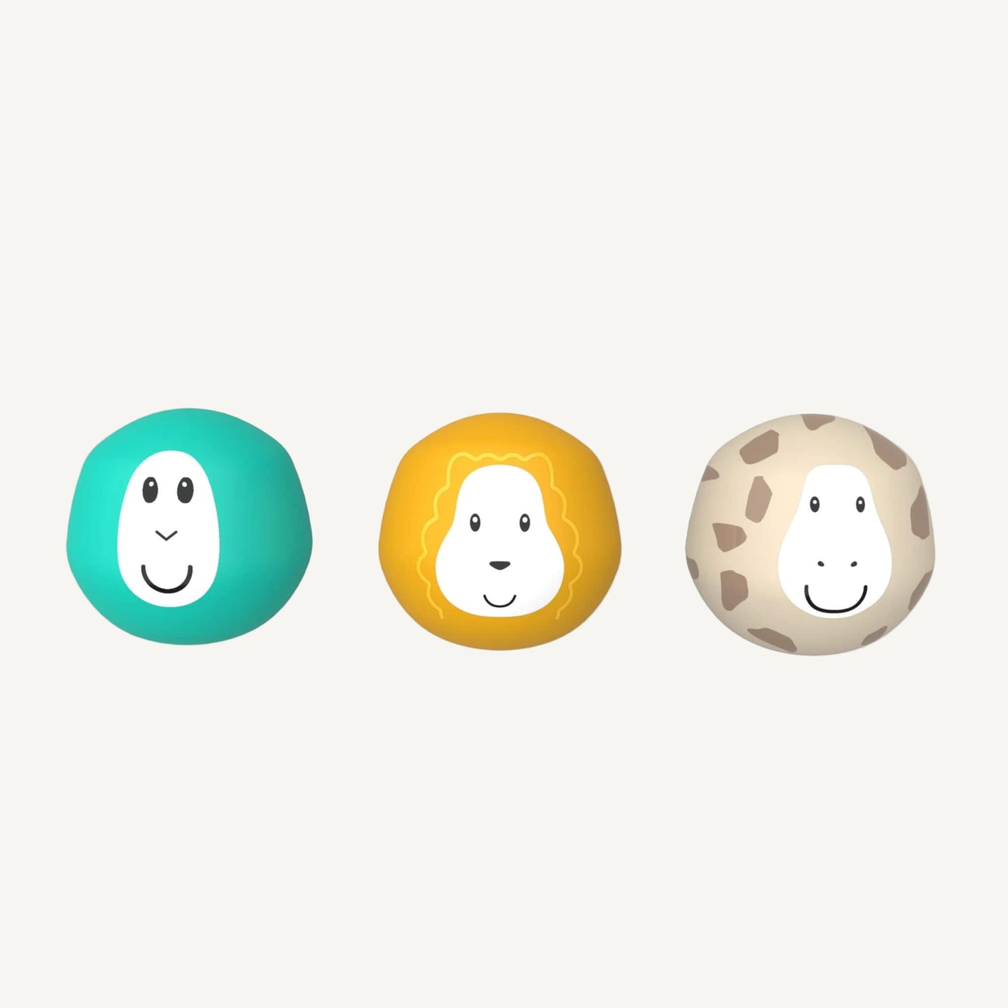 Three round bath toy balls with smiling animal faces arranged in a row, including turquoise, yellow, and beige characters.