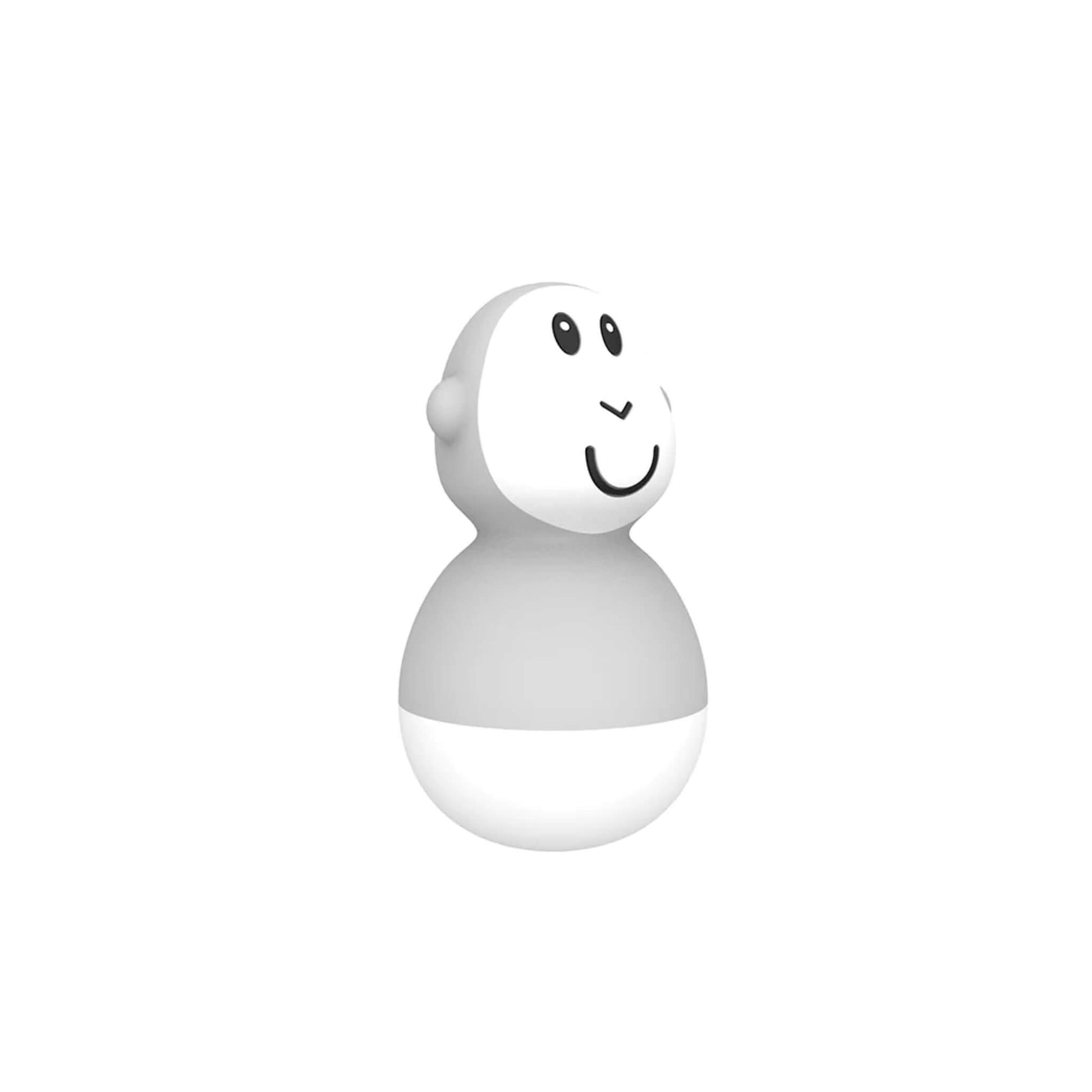 A grey wobbling bath toy shown upright on a plain white background, highlighting its smooth rounded shape and smiling face.