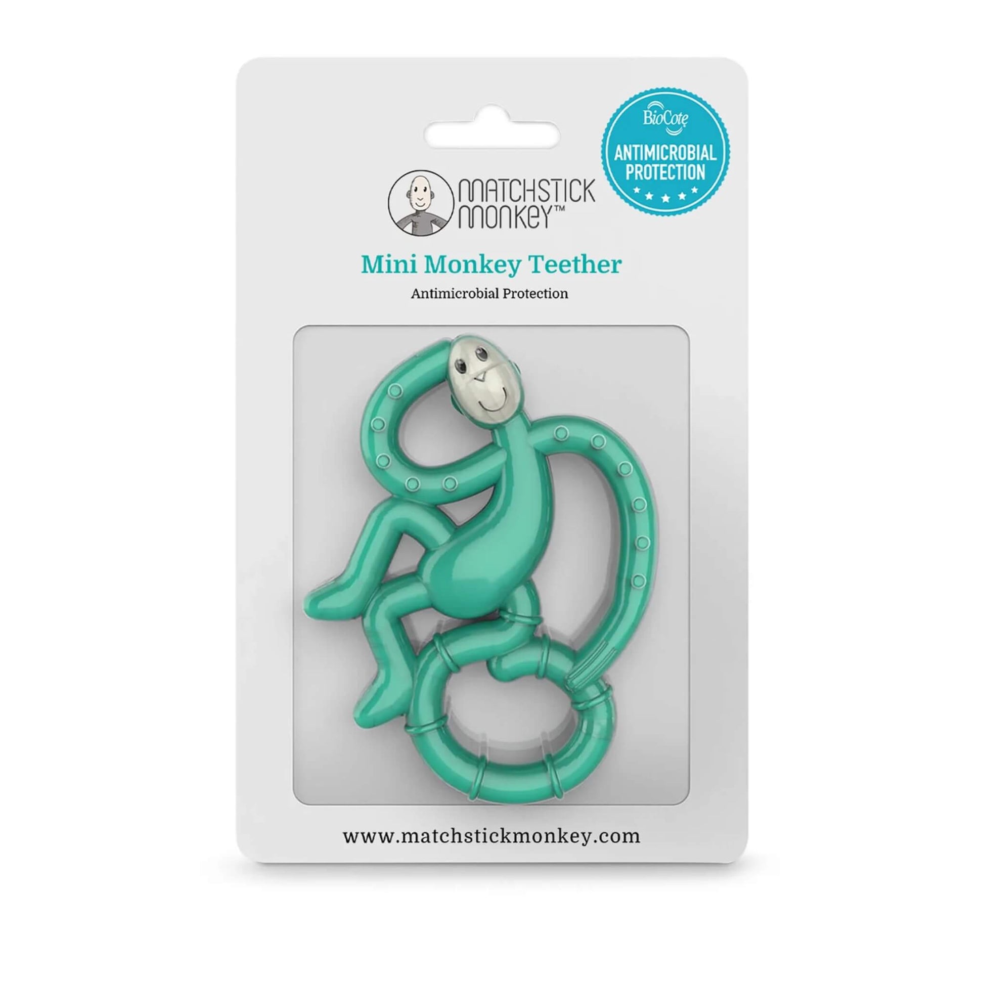 A green monkey-shaped teether is shown inside retail packaging with a clear window that displays the character shape and textured details.