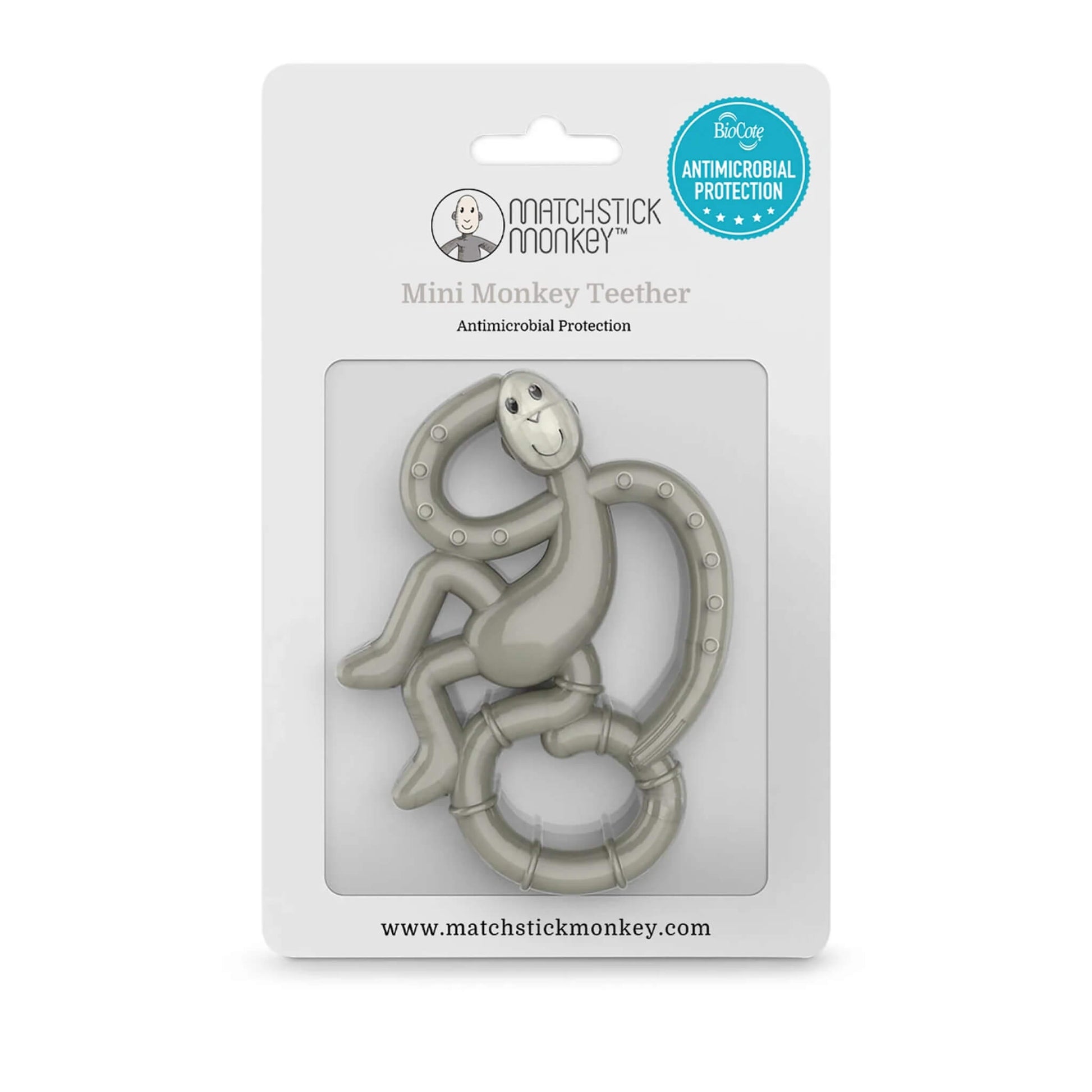 A grey monkey-shaped teether inside its retail packaging, displayed against a white card backing with antimicrobial protection badge.