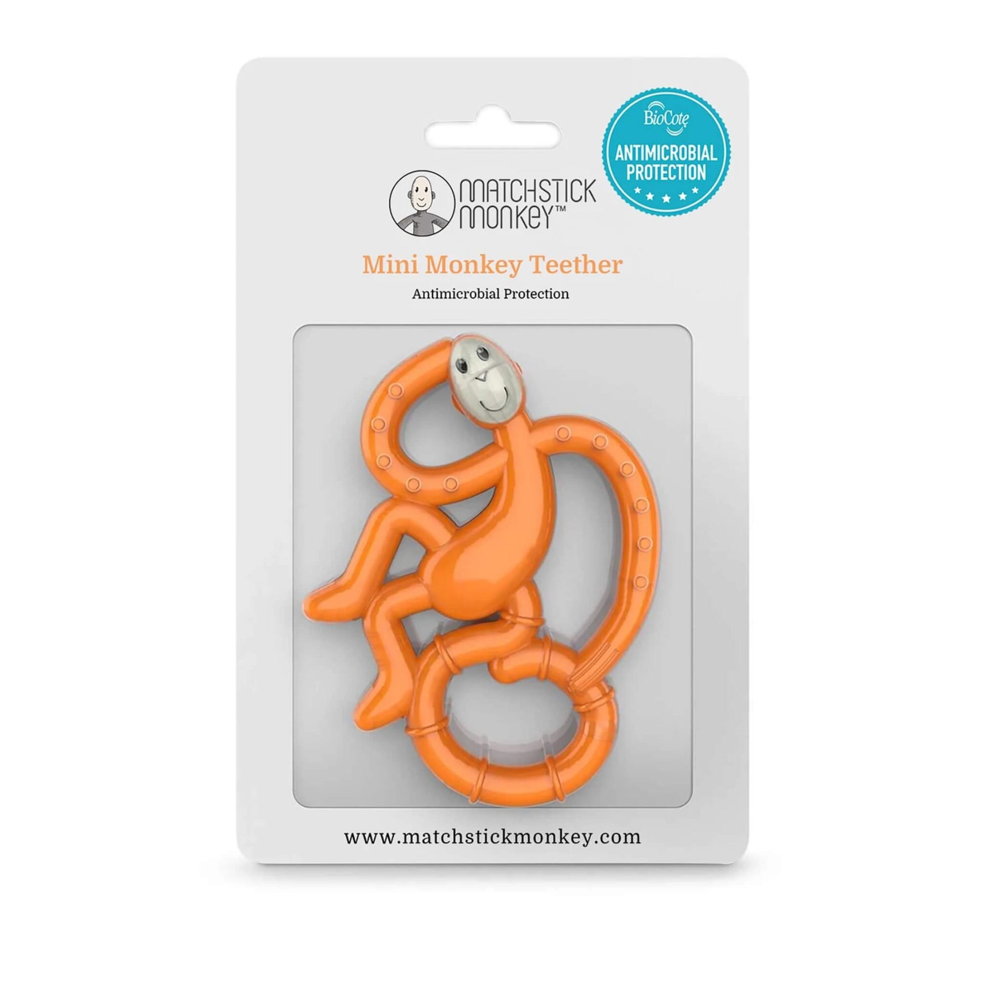 An orange monkey-shaped teether inside its retail packaging, displayed against a white card backing with antimicrobial protection badge.