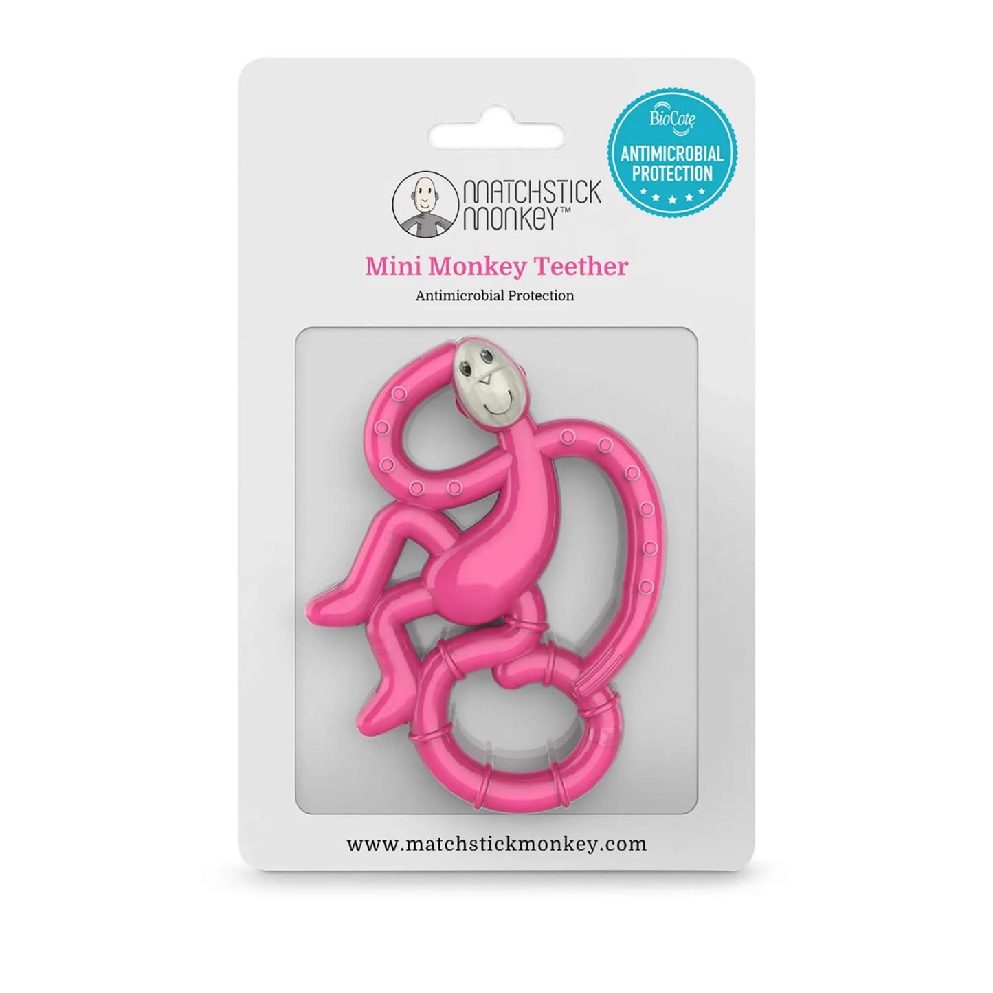 A pink monkey-shaped teether inside its retail packaging, displayed against a white card backing with antimicrobial protection badge.