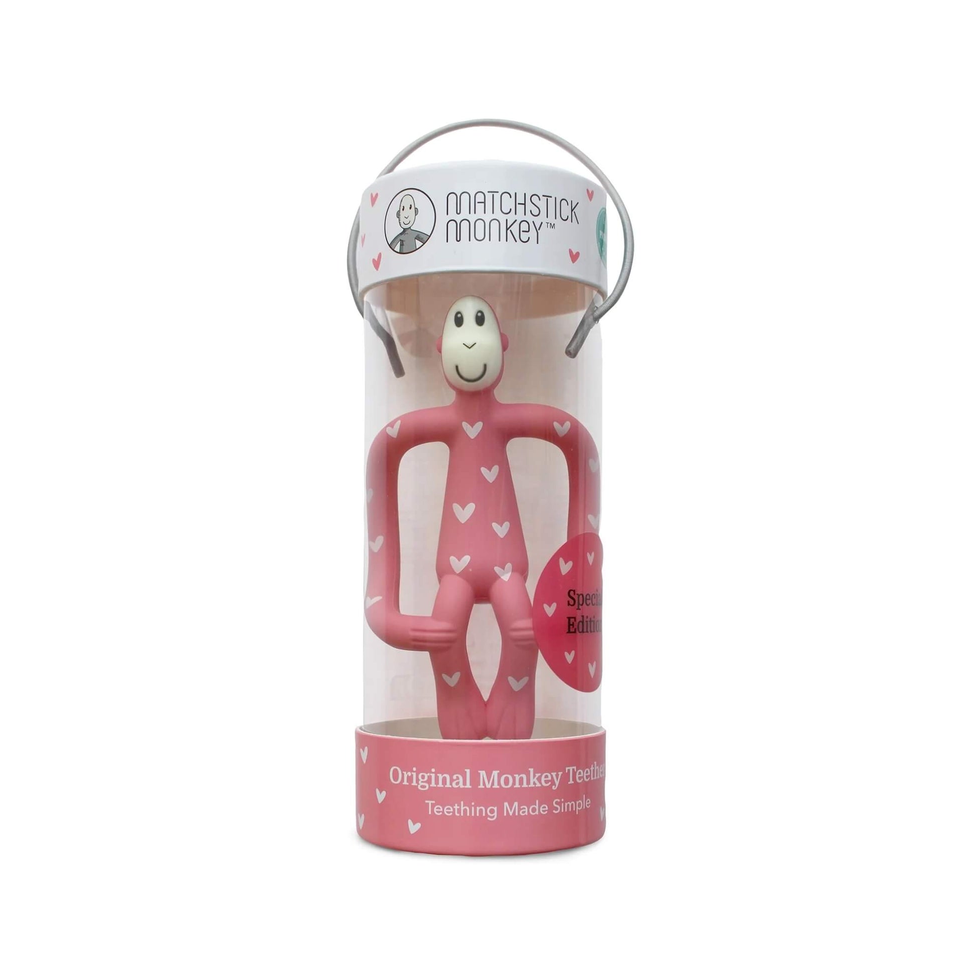 Pink heart-patterned monkey teether displayed inside a clear Matchstick Monkey presentation tube with carry handle.