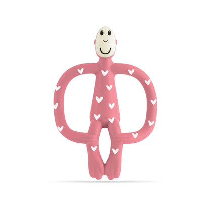Pink silicone monkey-shaped teether with white heart pattern shown against a plain background.