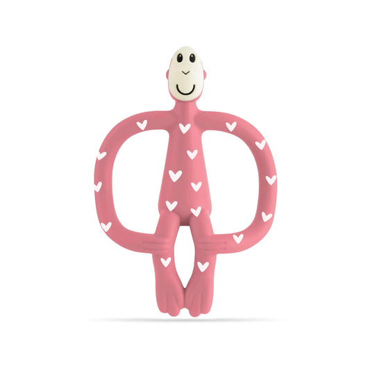 Pink silicone monkey-shaped teether with white heart pattern shown against a plain background.