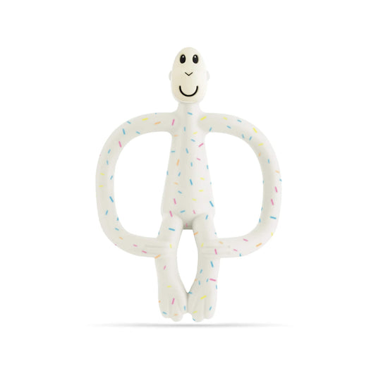 A Confetti Cream Matchstick Monkey Original Teething Toy shown upright, with a soft white silicone body covered in small colourful speckles and wide looped arms for babies to hold.