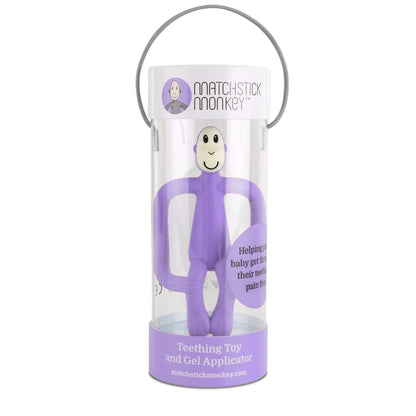 A purple monkey-shaped silicone teether displayed inside a clear cylindrical gift tube with a matching purple base and carry handle.