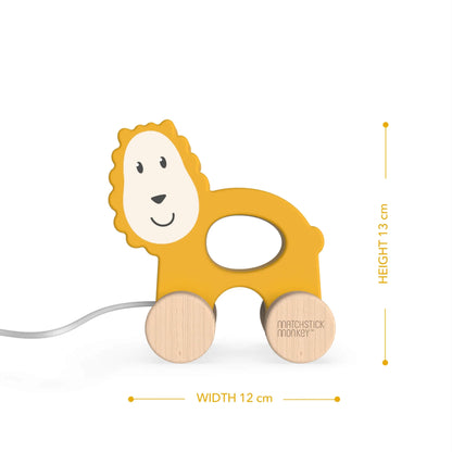 A wooden lion pull-along toy with a cut-out centre and beechwood wheels displayed with height and width measurements beside it.