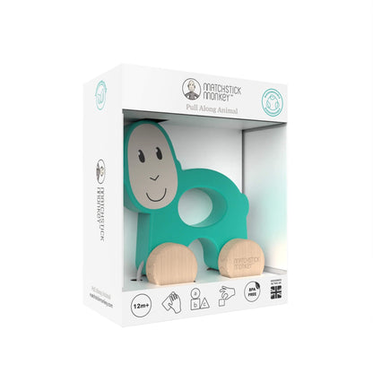 A boxed Matchstick Monkey pull-along monkey toy packaged in a white display box with a clear front panel.