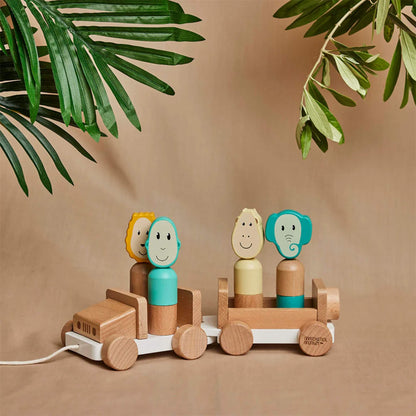 Wooden safari jeep toy set on a neutral backdrop with green leaves overhead, with animal figures placed upright in the seats.