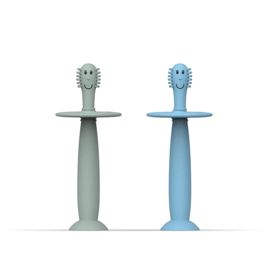 Matchstick Monkey Training Toothbrush with Stopper baby toothbrush set in mint green and light blue silicone with wide safety guards and suction cup bases.