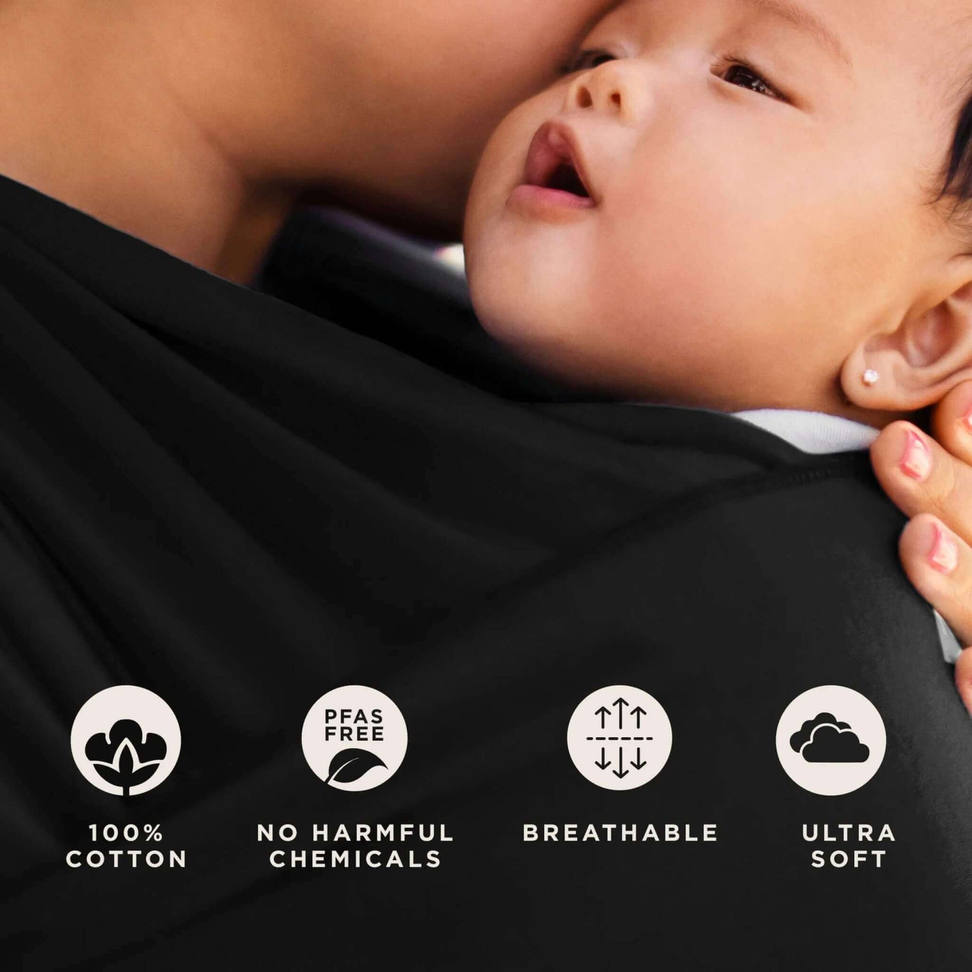 Close-up of baby resting against soft black fabric beside icons showing 100% cotton, PFAS free, breathable and ultra-soft features.