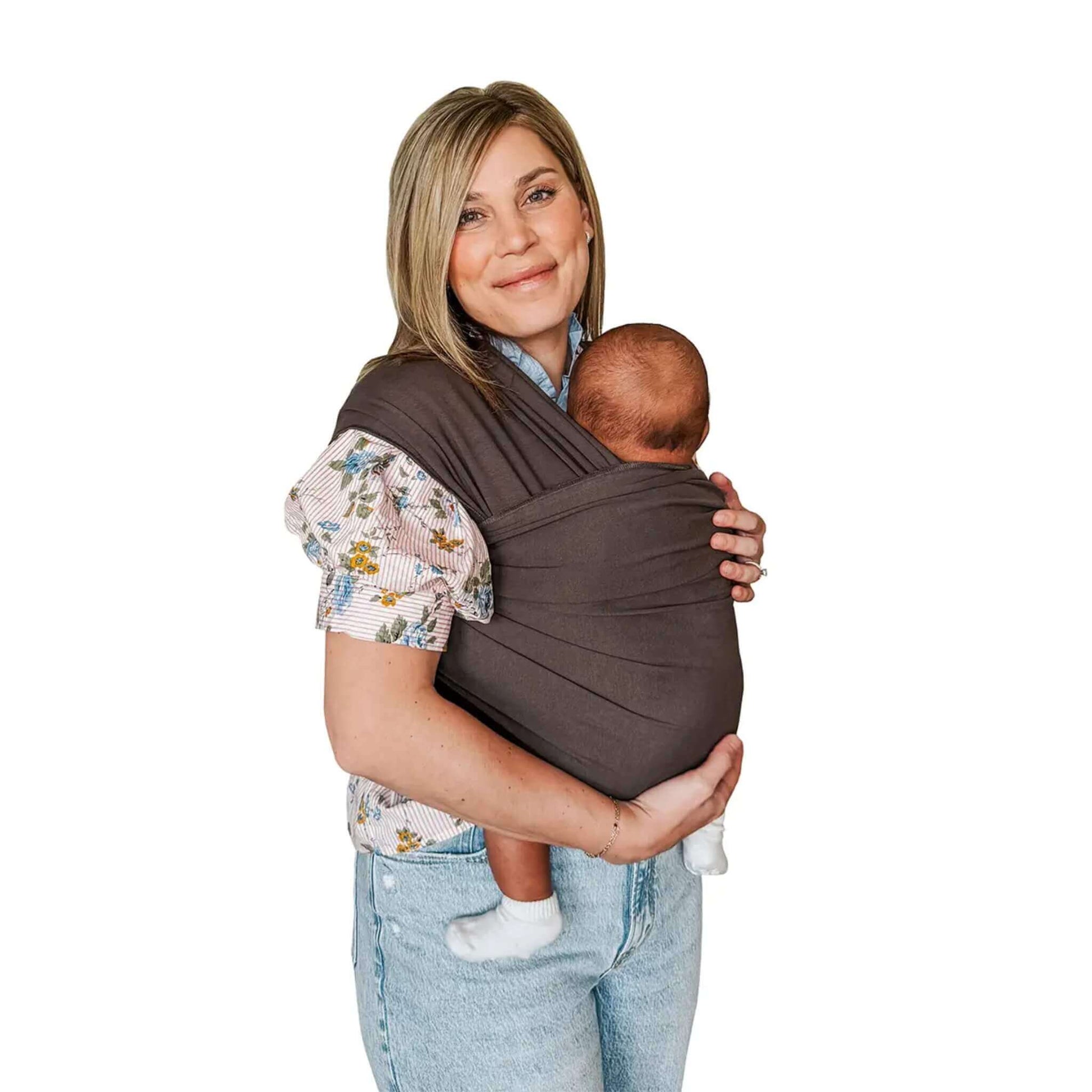 A mother wearing the Moby Classic Baby Wrap in Hickory brown, holding her baby securely against her chest.