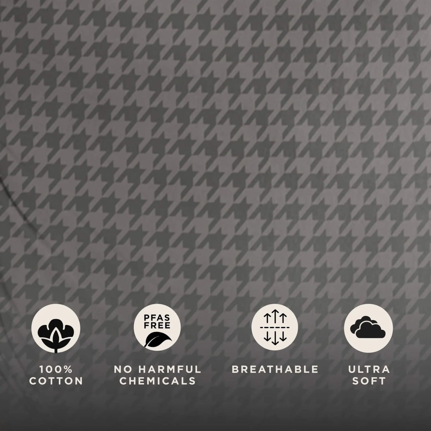 Close-up of grey houndstooth fabric showing cotton texture with icons indicating cotton material, no harmful chemicals, breathability and softness.