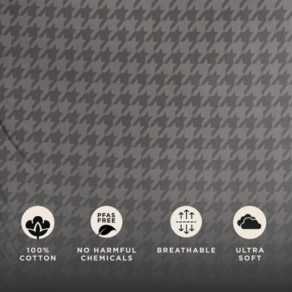 Close-up of grey houndstooth fabric showing cotton texture with icons indicating cotton material, no harmful chemicals, breathability and softness.