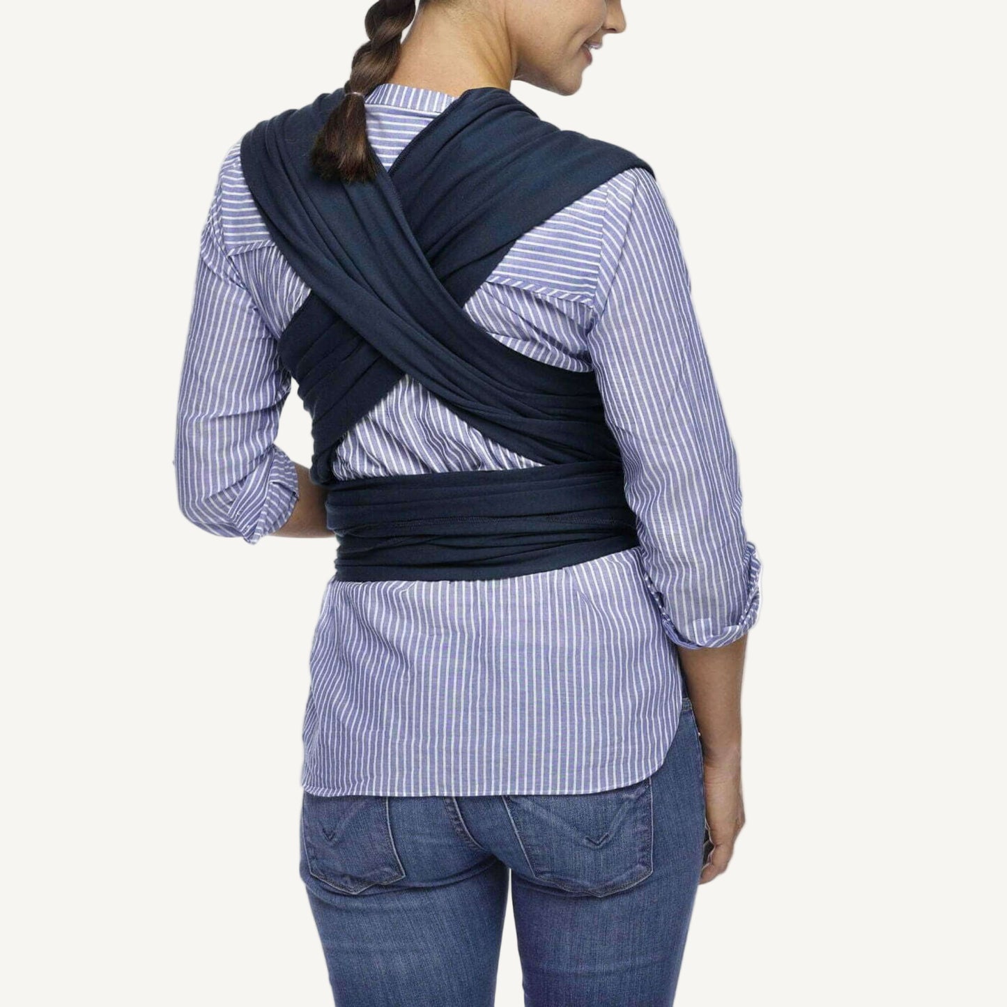 Back view showing the cross-over straps of a Midnight navy baby wrap tied securely around the waist.