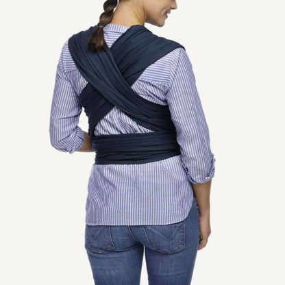 Back view showing the cross-over straps of a Midnight navy baby wrap tied securely around the waist.