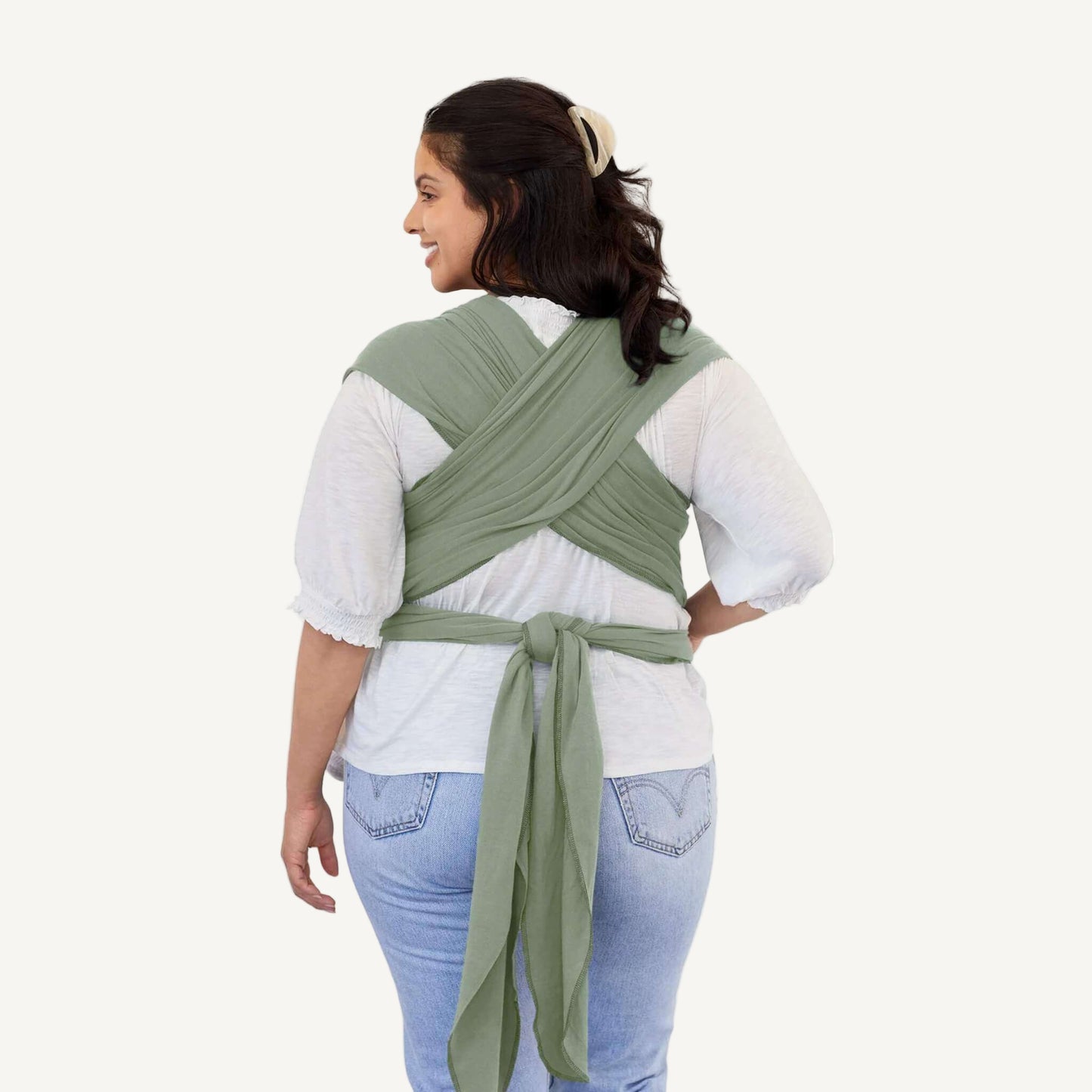 Back view showing the crisscrossed straps and tied ends of a Pear green baby wrap.