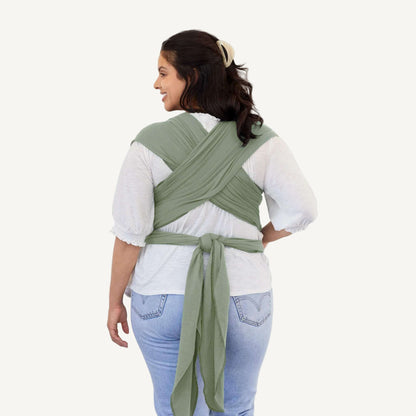 Back view showing the crisscrossed straps and tied ends of a Pear green baby wrap.