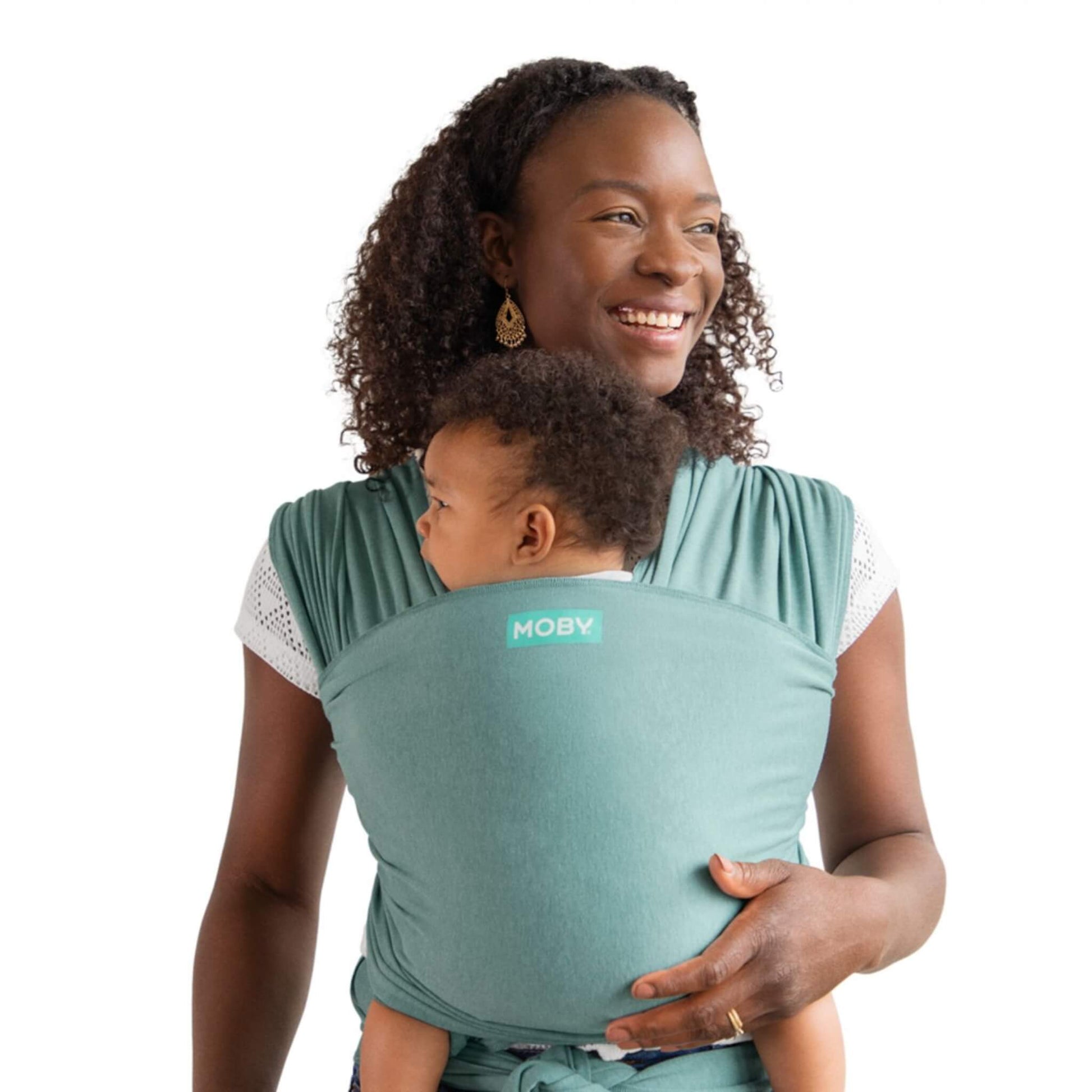 Moby Elements Baby Wrap in a soft teal shade shown in a front-carry position with a parent holding a baby close, fabric wrapped securely for support.