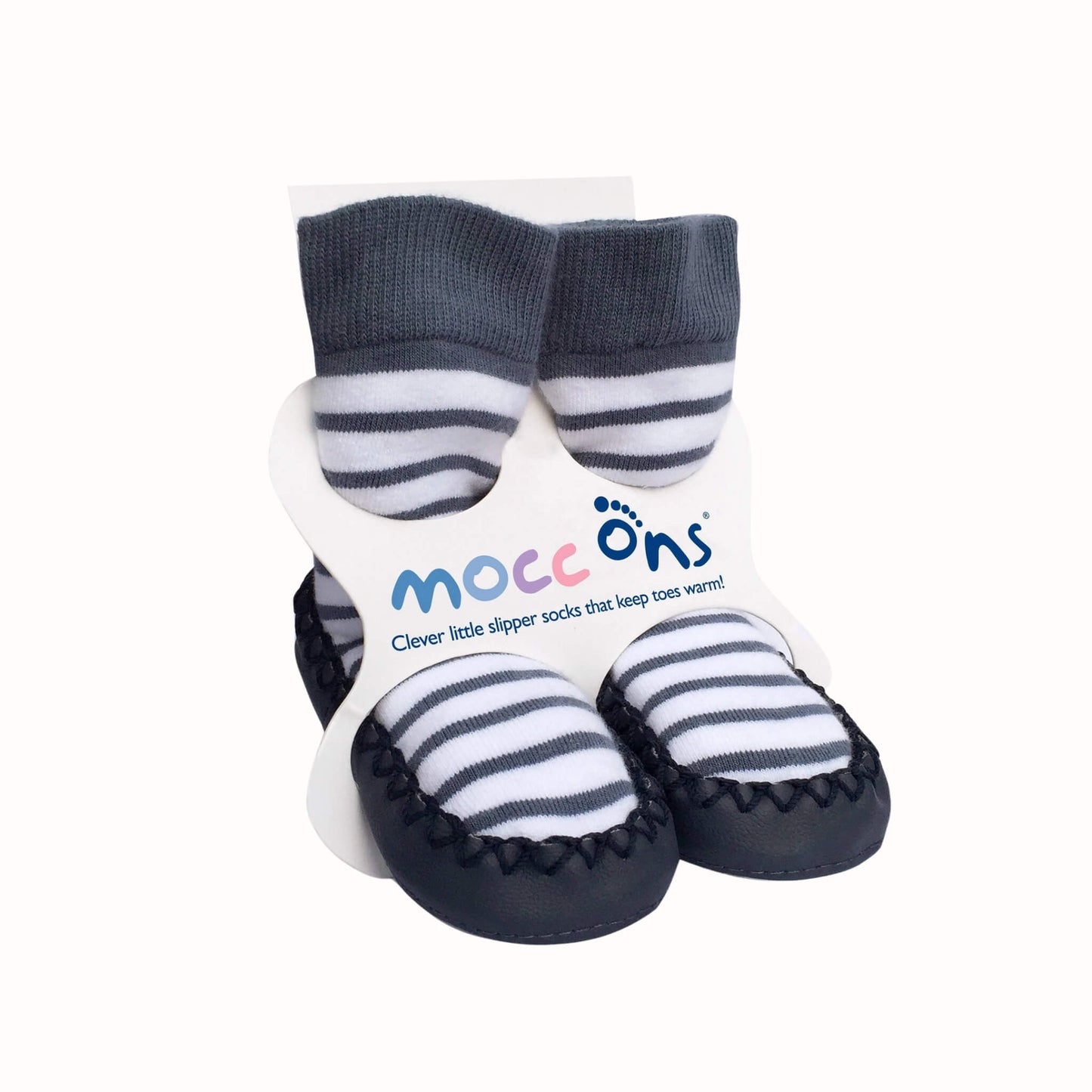 Pair of navy and white striped baby slipper socks with dark navy cuffs and soft navy soles attached to Mocc Ons packaging.