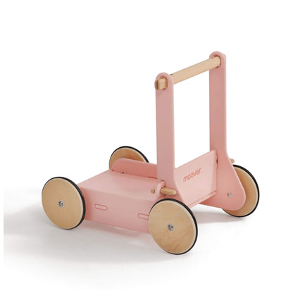 Moover Baby Walker in pink with a natural wood handle and rubber-lined wooden wheels, designed to support babies learning to walk safely.