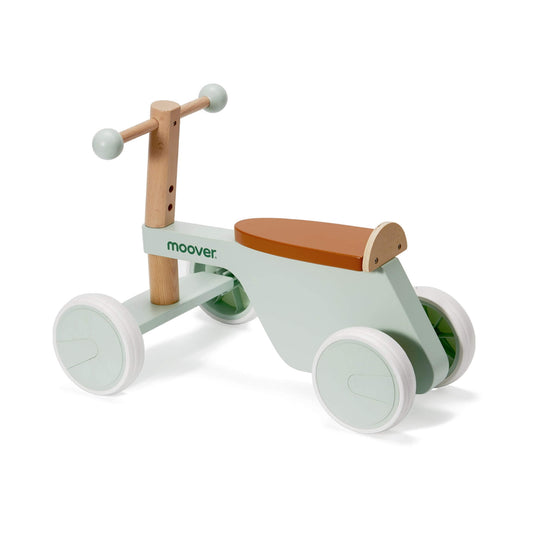 Pastel green wooden ride-on bike with tan seat shown from side angle on white background.