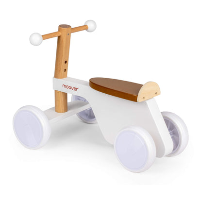 Side view of a white wooden ride-on bike with rounded handle grips, white wheels, and a natural wood handlebar and frame.