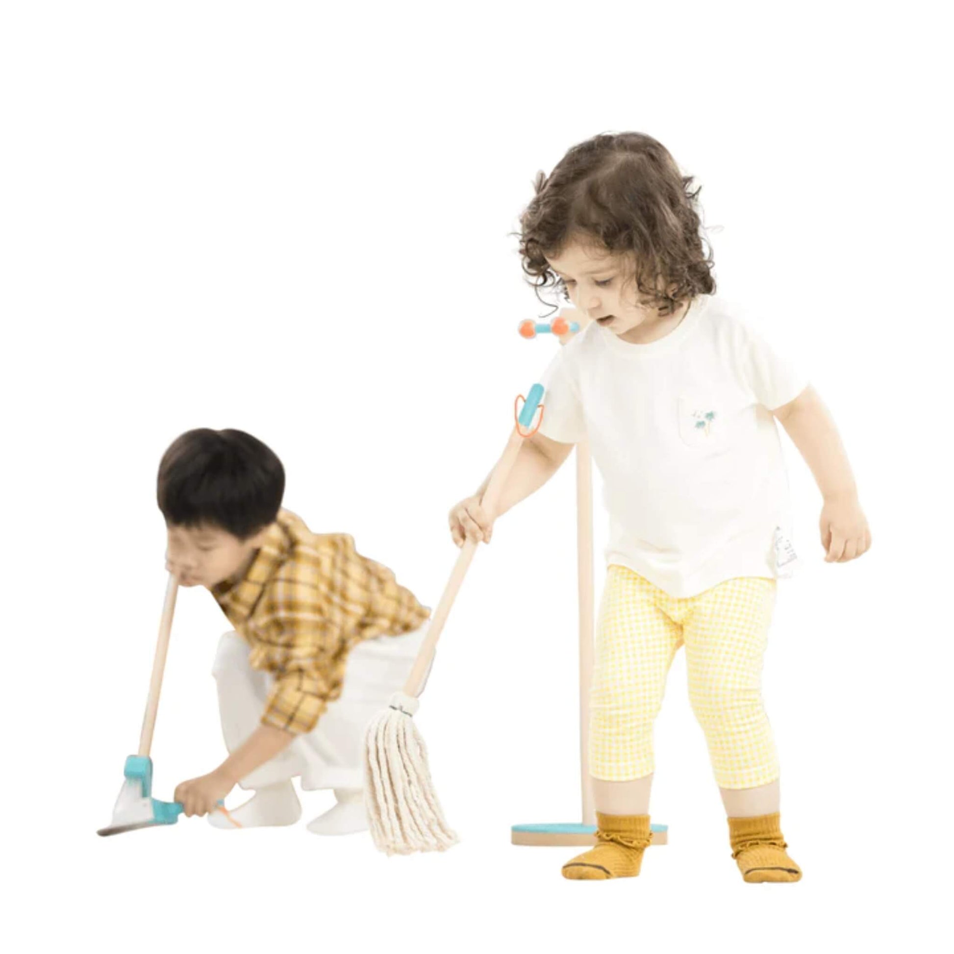 Young girl pretending to mop with the Moover Cleaning Set, while boy uses the dustpan on the floor.