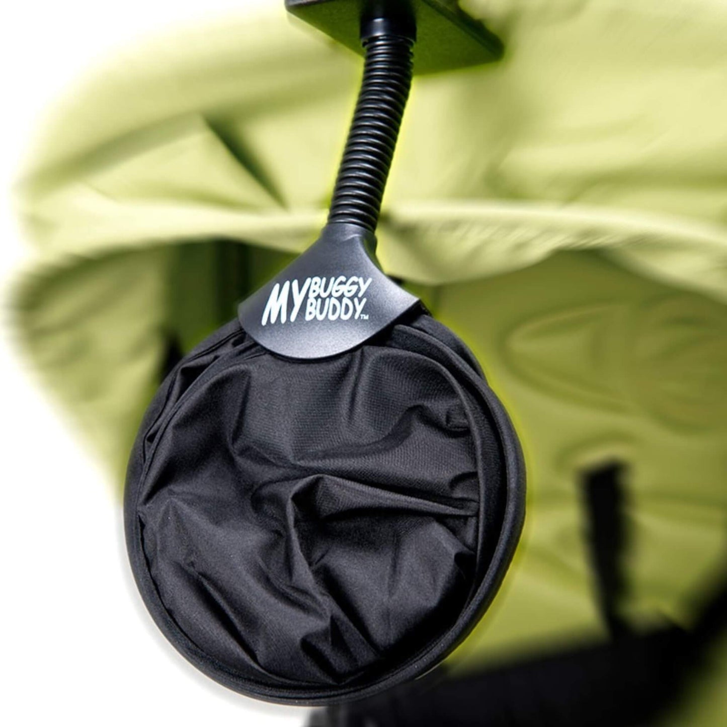 Foldable circular baby sunshade neatly compacted for easy storage in a pram basket or travel bag.