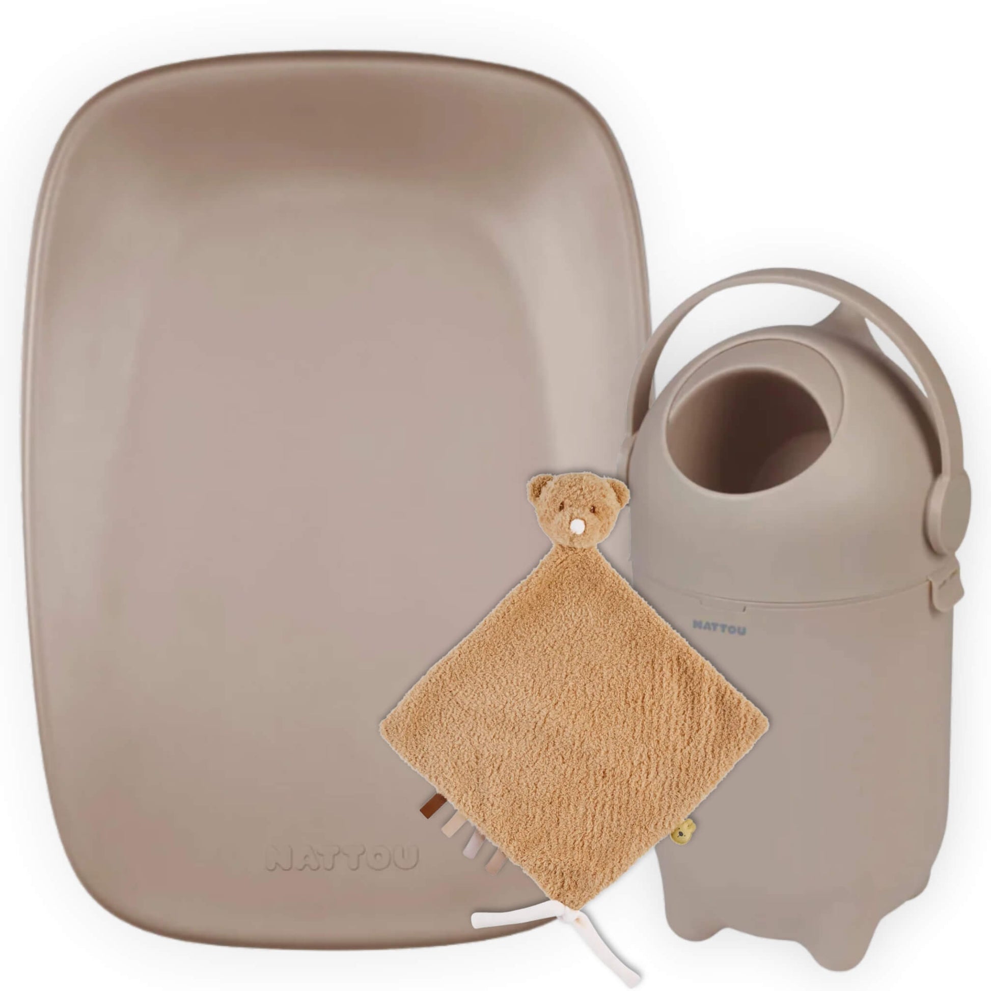 Soft taupe baby changing mat beside a matching rounded nappy bin with carry handle, styled with a small beige teddy comforter blanket in front on a plain background.