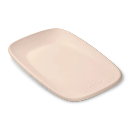 Nattou Softy Changing Pad in beige shown from above with its smooth contoured surface and raised edges visible.