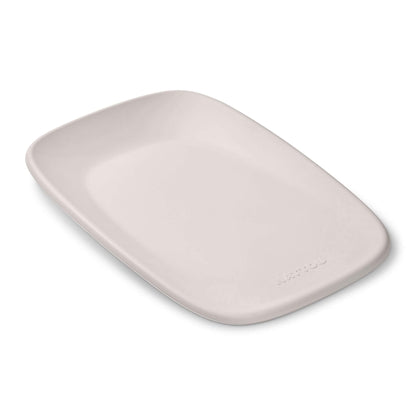 Nattou Softy Changing Pad in a smooth clay colour shown from above, with its contoured wipe-clean surface and rounded edges visible.