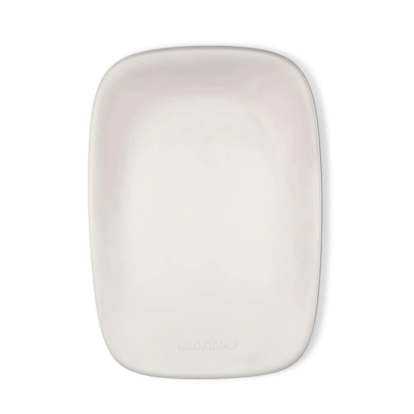 A top-down view of a clay-coloured changing pad with a smooth, contoured surface and soft rounded corners.