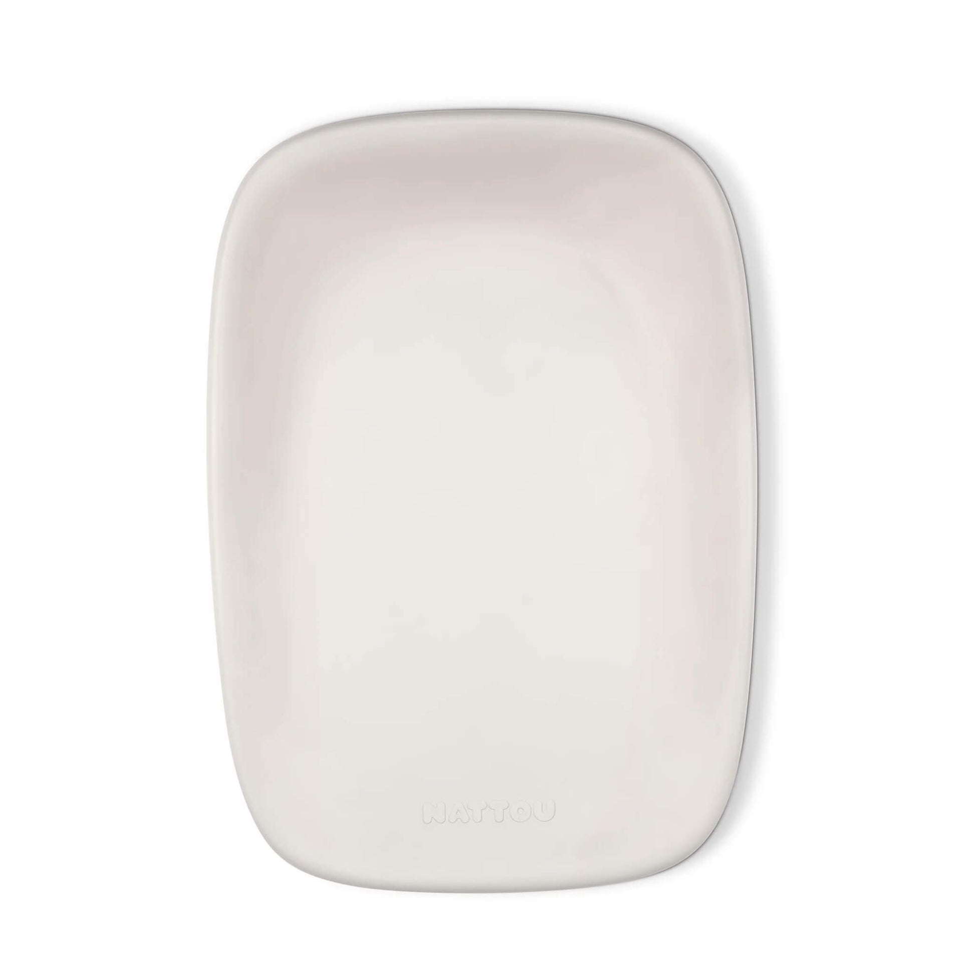 A top-down view of a clay-coloured changing pad with a smooth, contoured surface and soft rounded corners.