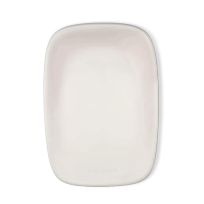 A top-down view of a clay-coloured changing pad with a smooth, contoured surface and soft rounded corners.