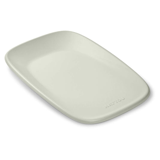 Nattou Softy Changing Pad in soft green shown from above with its smooth contoured surface and raised edges visible.