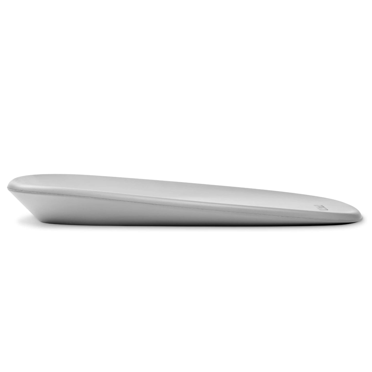 Side view of a grey contoured changing pad with a gentle slope and smooth rounded edges.