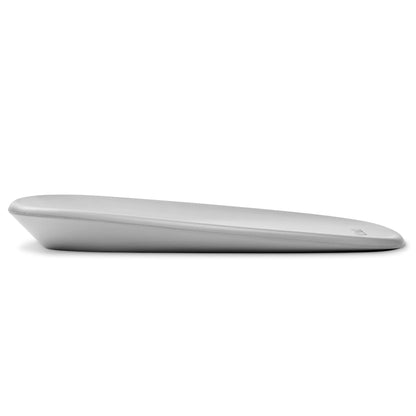 Side view of a grey contoured changing pad with a gentle slope and smooth rounded edges.