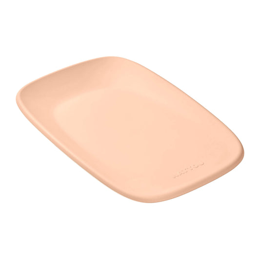 Nattou Softy Changing Pad in peach shown angled from above with its smooth, seamless surface and gently raised sides for a secure changing space.
