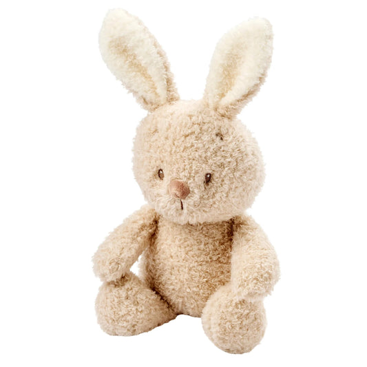 Nattou Teddy Baby Bunny shown sitting upright with long textured ears, rounded limbs and soft teddy fabric in a pale beige tone.