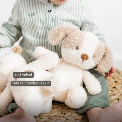 A close view of a cream and beige dog soft toy resting in a child’s lap, showing its soft textured fabric and floppy ears.
